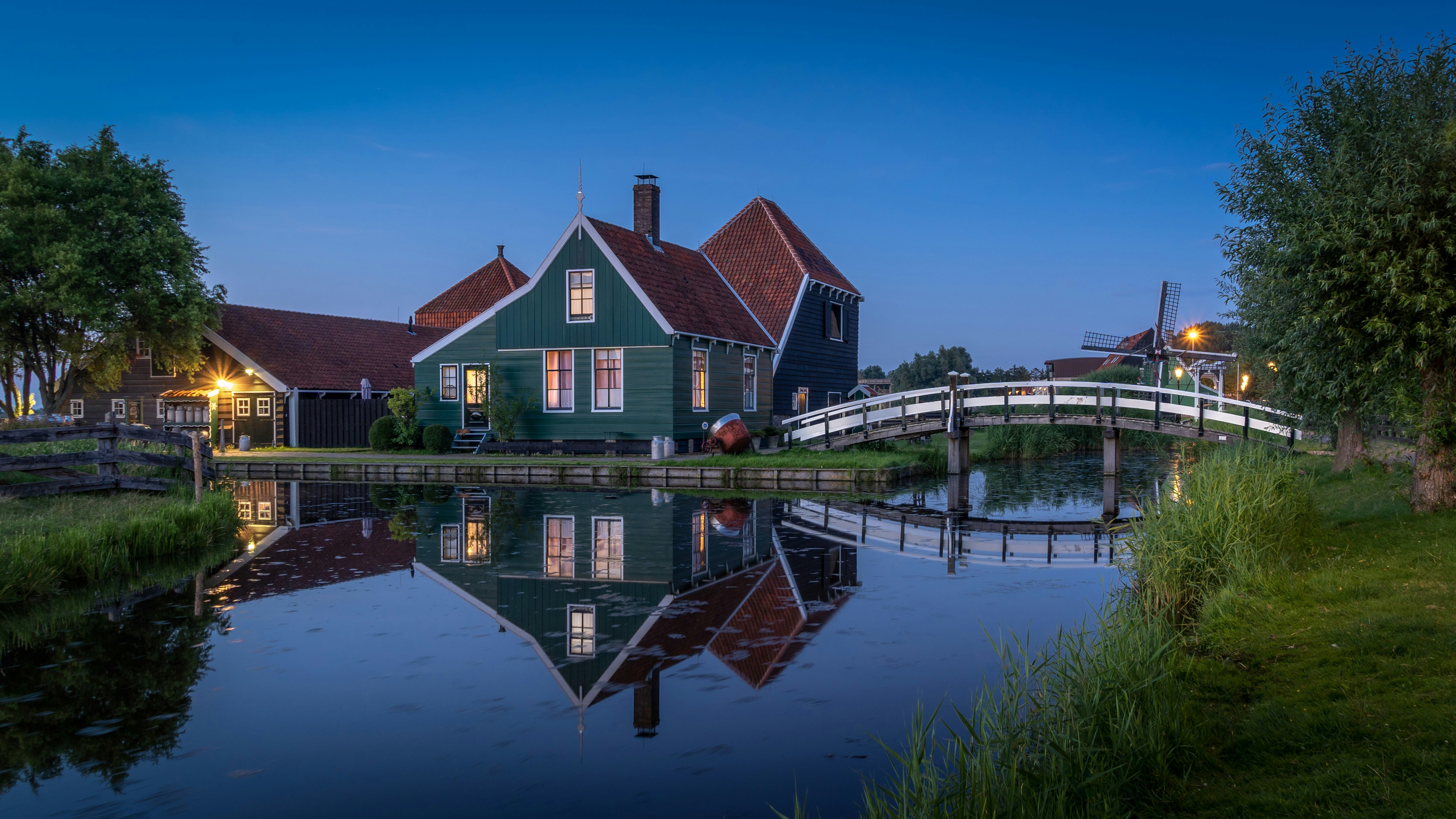 brown and white house beside body of water during daytime